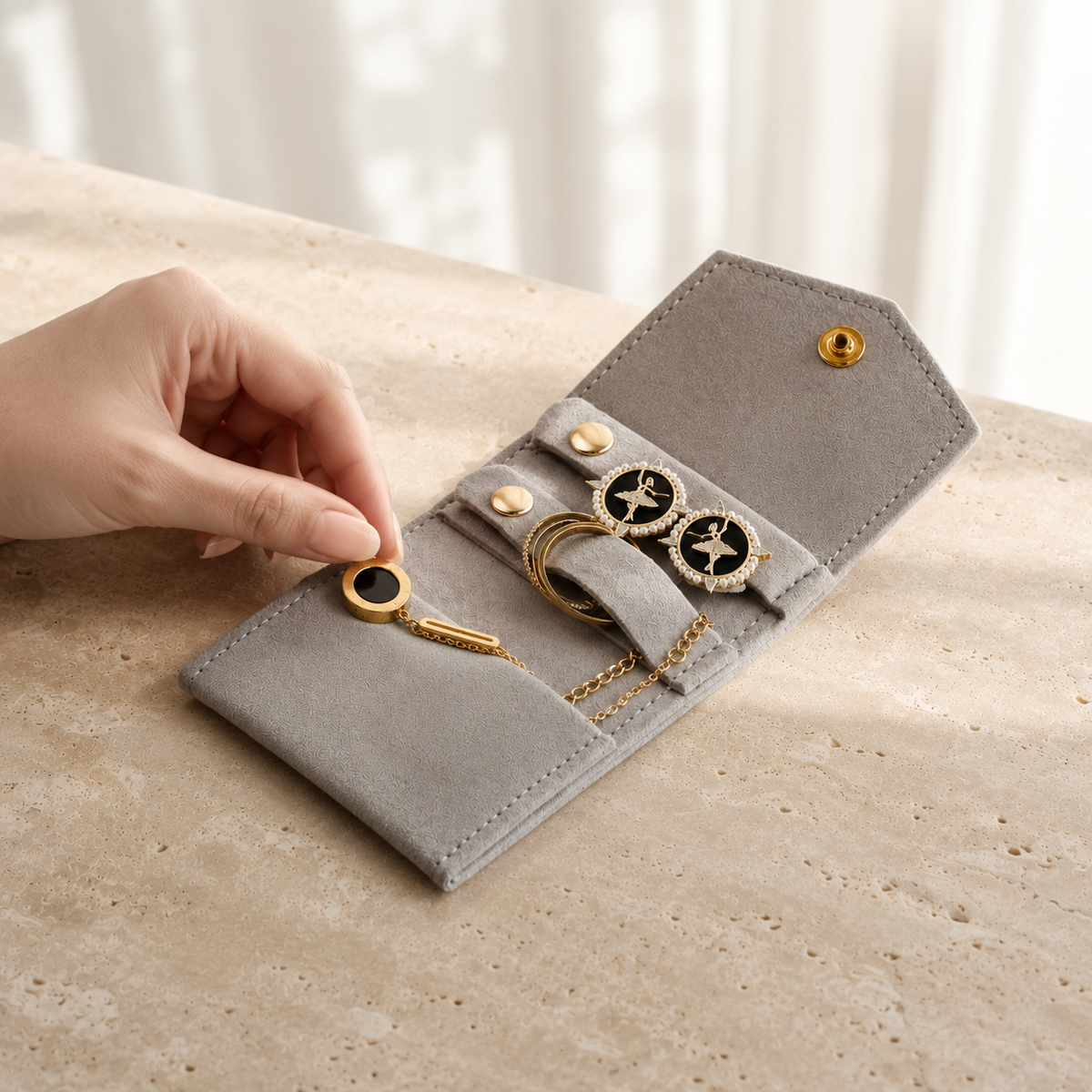 Pochette Bijoux Voyage Suédine en situation (Gris), main pour reference d'echelle