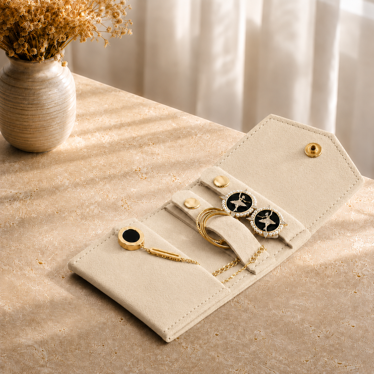 Pochette Bijoux Voyage Suédine presente en situation (Beige) avec vase de fleurs sechees en arriere-plan